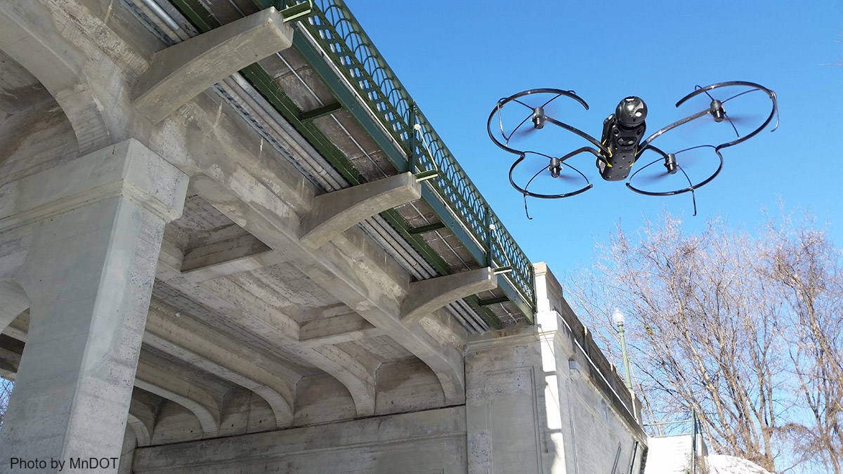 Flying drone inspects bridge improves transportation performance by advancing innovation.