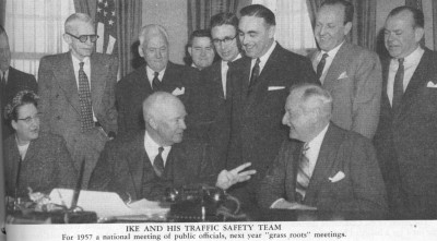 President Eisenhower talks to Harlow H. Curtice (seated on right), Chairman of the President's Committee for Highway Safety. Other members include newspaper executive William Randolph Hearst, Jr., (back row, second from right) and the only woman on the Committee, Mrs. Raymond Sayre of Iowa.