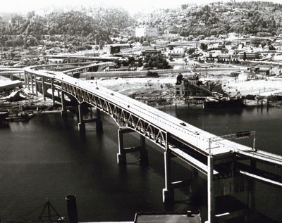 Oregon- The Marquan Bridge gives motorist in the Portland area direct and easy access to the Banfield, Baldock, and Stadium Freeways. The opening of the bridge has reduced traffic congestion in this area considerably. The uncompleted section of the span in lower right corner of picture will connect to the Mr. Hood Highway (US26) in the future.