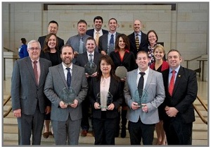 Photo shows award winners holding their trophies.