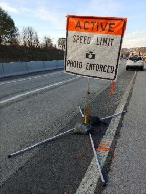 Sign reads Active Speed Limit Photo Enforced.