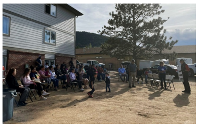 This photo depicts the community celebration, including many adults and children.