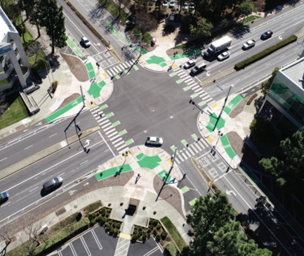 Aerial photo of an intersection featuring separated and dedicated bike lanes and pedestrian facilities.