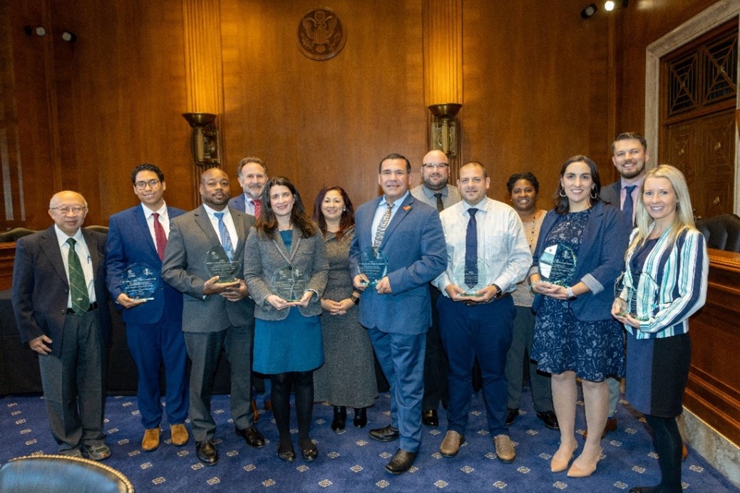 Road safety award winners holding their award plaques.