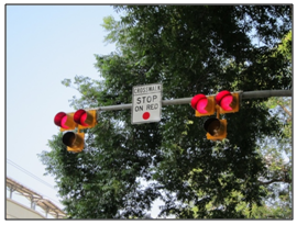 Photo of a pedestrian hybrid beacon mounted to a mast arm.