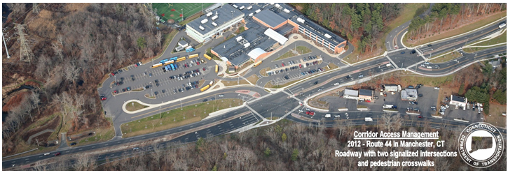 Aerial photo depicting a road segment where intersections and a shopping area have been carefully designed for safe access.