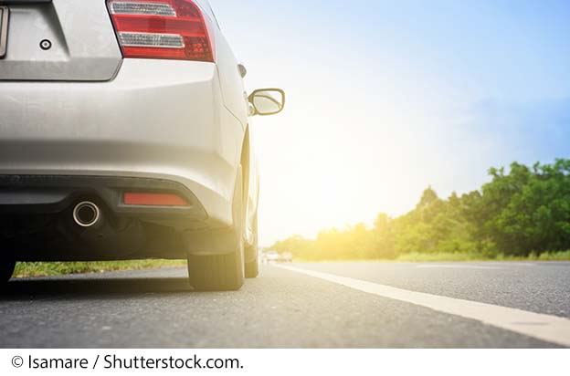 "Close up of the wheels of a vehicle on a highway. Image source: © Isamare / Shutterstock.com."