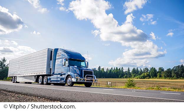 "A commercial truck on a highway. Image source: © Vitpho / Shutterstock.com."