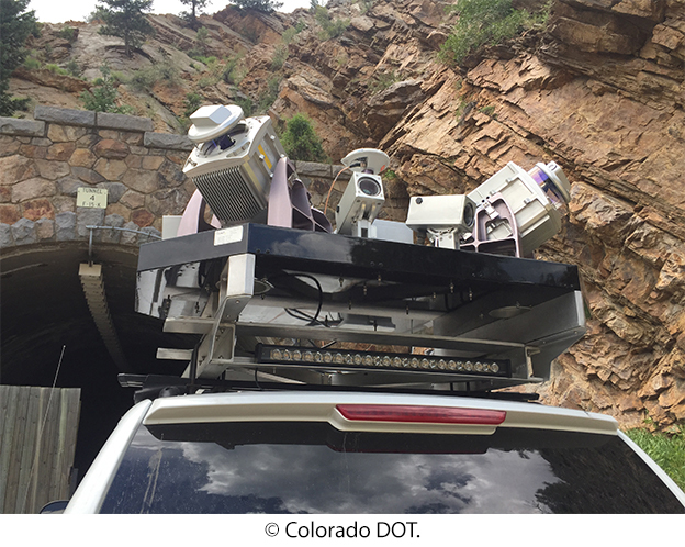 Advanced nondestructive evaluation equipment mounted on the roof of a truck in front of a tunnel. © Colorado DOT.