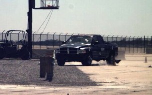 "First in a series of three photos of a truck hitting a guardrail end terminal during crash testing. Approaching impact."