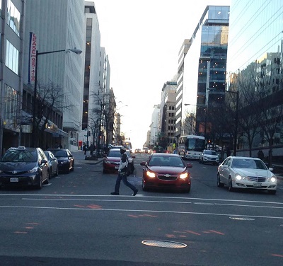 a pedestrian rossing a city street