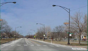 Three-lane cross-section with bollard-separated bicycle lanes. Photo: Stacey Meekins