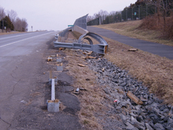 Photo. This photo shows a partially destroyed energy absorbing end treatment.