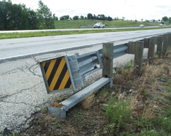 Photo. This photo shows an end treatment that is on a rail with a broken first post.