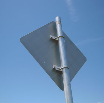 "Photo. The rear of a sign backed with aluminum is shown."