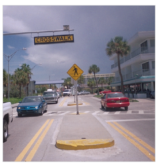 Figure 11. A picture of a raised median island with yellow surfacing on the vertical curb and the top of the nose of the island.