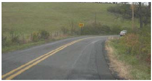 ""Curving road with an arrow sign.