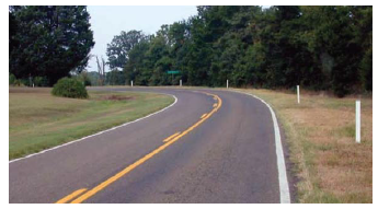 "alt="Post-mounted delineators on the shoulder of a horizontal curve.""