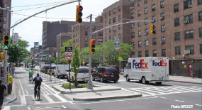 Bicycle lane, parking, and pedestrian refuge island on Ninth Avenue.