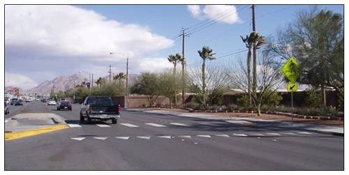 Photo of advance yield pavement markings and signage in advance of a crosswalk with a Danish offset.