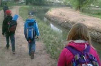 Photo: Caption: Figure 17: Students Walking to School along the Acequias.