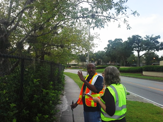 "Members of the audit team discussing a thick stand of vegetation on a curve that may inhibit line of sight for turning traffic."