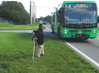 "A disabled woman accessing a LYNX bus."