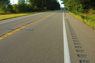 "A rural two-lane roadway treated with center line and shoulder rumble strips."