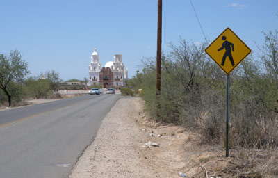 Page 23 photo. This image shows a road with a pedestrian crossing sign, but no pedestrian facilities.