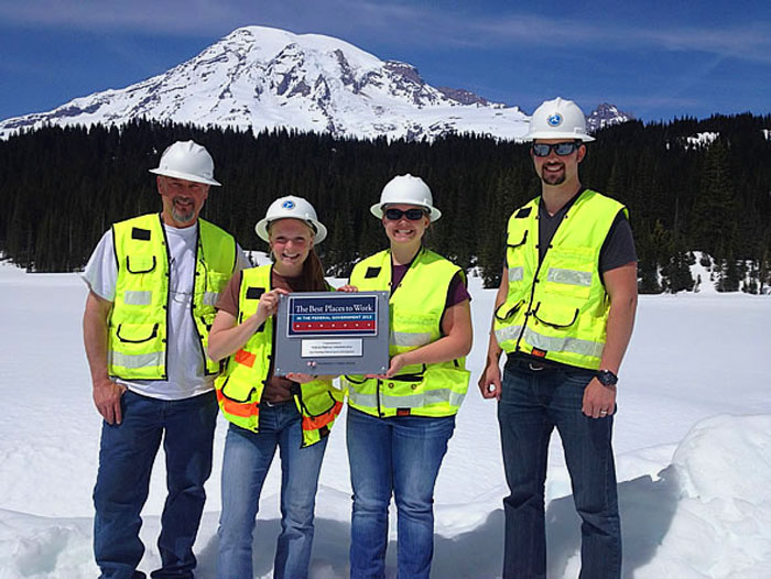 Western Federal Lands Highway Division staff pose with the Best Places to Work plaque at Mt. Rainier National Park, Washington