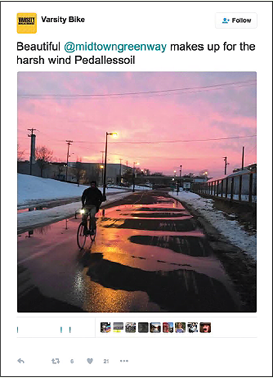 Screen capture. Twitter user @VarsityBikes tweeted: “Beautiful @midtowngreenway makes up for the harsh wind Pedallessoil.” The tweet included a photo of the snowy Midtown Greenway at dusk with a cyclist on the path.