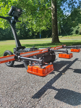 A Density Profiling System on pavement with trees in the background