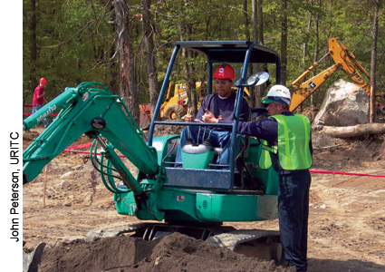 A training instructor is demonstrating how the controls work in this mini excavator. More than 1,000 students from across the State learned about careers in the construction and transportation industry while participating in Rhode Island Construction Career Days in 2005.