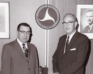 Then-Federal Highway Administrator Francis C. Turner (left) poses with Emmett H. Karrer, the first director of NHI, in September 1971.