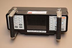 "Ultrasonic tomographer (MIRA).  This photo is a top view of an ultrasonic tomographer (MIRA), showing the LCD liquid-crystal display and control panel of the tomographer. The tomographer is rectangular with two rotating handles mounted near its ends and a LED light-emitting diode screen in the center."