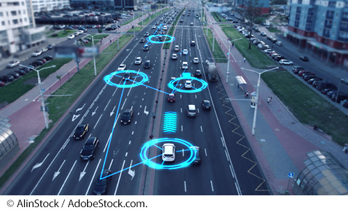 A traffic-filled roadway with circles around some vehicles and a line between them, indicating they’re connected vehicles. Image © AlinStock / AdobeStock.com.