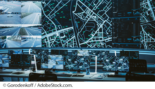 Multiple TV screens and large monitors show live traffic, street maps, and data. Image © Gorodenkoff / AdobeStock.com.