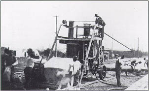 Photo: Charging the concrete mixer for the experimental concrete road in Chevy Chase, MD.