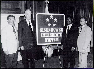 Unveiling the Eisenhower Interstate System sign: (Left to right) Representative Nick J. Rahall, WV, John Eisenhower (President Dwight D. Eisenhower's son), Administrator Rodney Slater, and Representative Norman Mineta, CA.