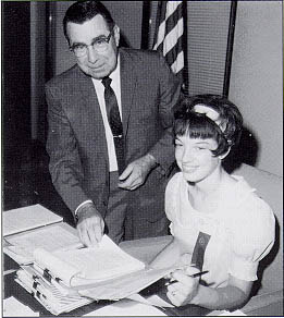 Miss Lynda Sue Plambeck, Girls Nation "Federal Highway Administrator for the Day," and Administrator Francis C. Turner pause briefly (for the photographer) from their work.