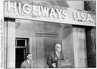 Promotion of the Interstate System -- With Administrator Rex Whitton looking on, Secretary of Commerce Luther H. Hodges opens "Highways, U.S.A.," an exhibit in the Department of Commerce Building lobby, marking 5 years of Interstate construction (1956-1961).