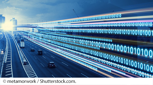 A highway with various vehicles and a city landscape alongside a series of numbers, consisting of ones and zeros. Image Source: © metamorwork / Shutterstock.com.