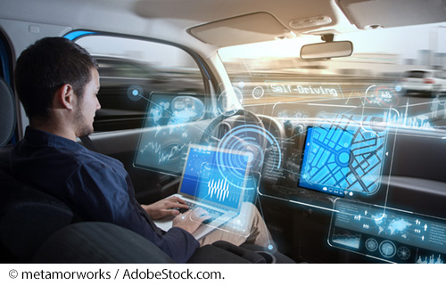 Interior of futuristic self-driving car where a person can work on their laptop while the car is moving overlaid with images of mapping screens on dashboard. Image: © metamorworks / AdobeStock.com.