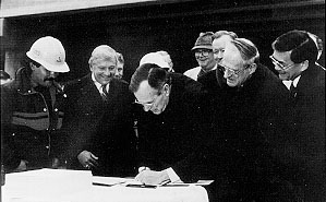 President George Bush signs ISTEA at site of highway project in Texas. From left to right: Texas construction worker Arnold Martinez, Representative Bud Shuster (PA), President George Bush, Senator Daniel Patrick Moynihan (NY, in hat), Representative John Paul Hammerschmidt (AR), Representative Robert A. Roe (NJ), and Representative Norman Y. Mineta (CA).