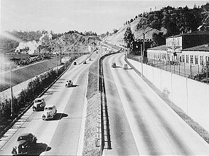 Original caption: On this section of the Arroyo Seco Parkway, opposing traffic proceeds on different levels seperated by railing and planted slopes.