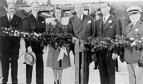 Official party at the ribbon cutting ceremony for the Arroyo Seco Parkway. From left to right: Amerigo Bozzani, Highway Commissioner and Chairman or the Celebration Committee; Director of Public Works Frank W. Clark; Sally Stanton, Queen of the 1941 Rose Festival; Governor Culvert L. Olson; Larry Barrett, Chairman, Highway Commission; and Ray Cato, Chief, State Highway Patrol.