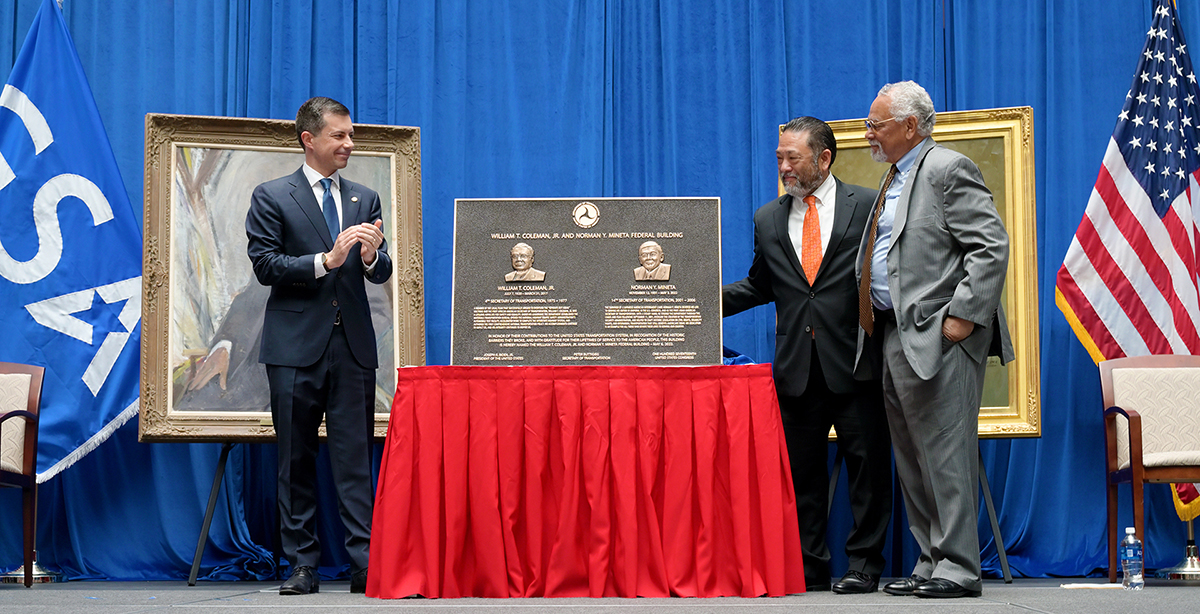 Secretary Buttigieg, David Mineta, and William Coleman III unveiling the plaque.