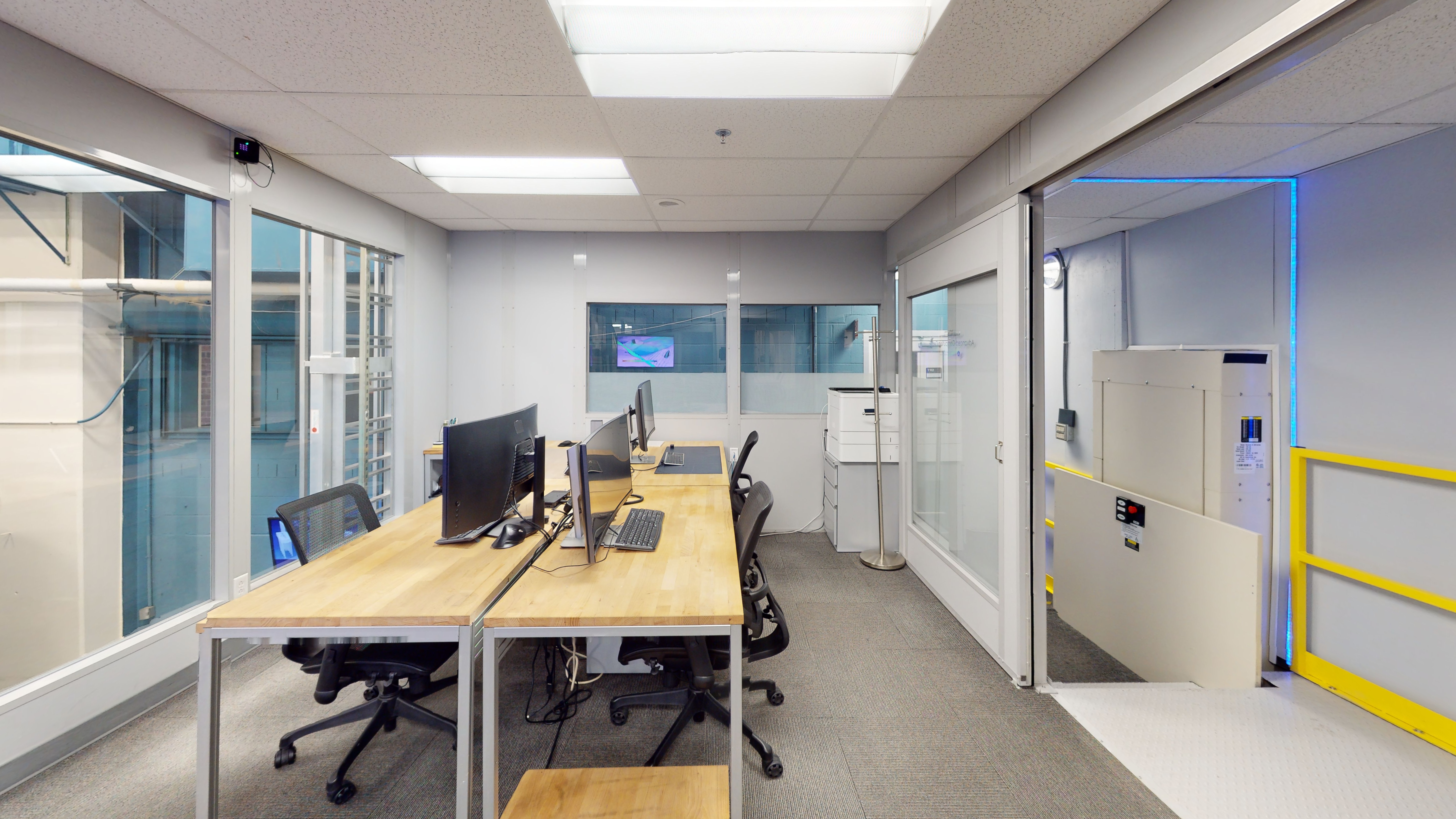 An office room with three workstation desks.