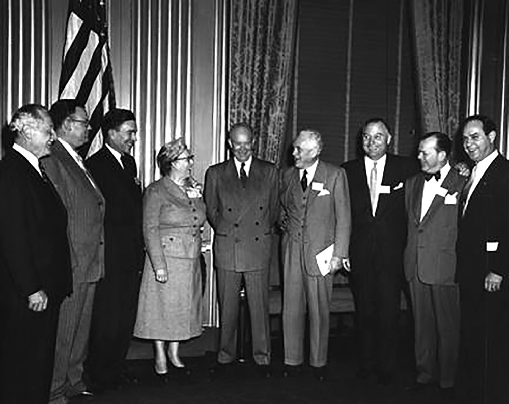 In the Oval Office at the White House, President Eisenhower announced creation of an Action Committee on Traffic Safety on April 13, 1954.  Standing next to the President are Mrs. Raymond Sayre of Iowa, the woman's representative, and Harlow H. Curtice, president of General Motors Corporation and chair of the committee.