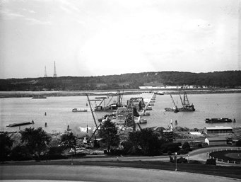 In May 1928, construction is underway on Arlington Memorial Bridge - seen looking towards Arlington National Cemetery. The Custis-Lee Mansion, now called Arlington House, can be seen on the Virginia side while to the left are the wireless towers of the Arlington Naval Radio Station. [Library of Congress]